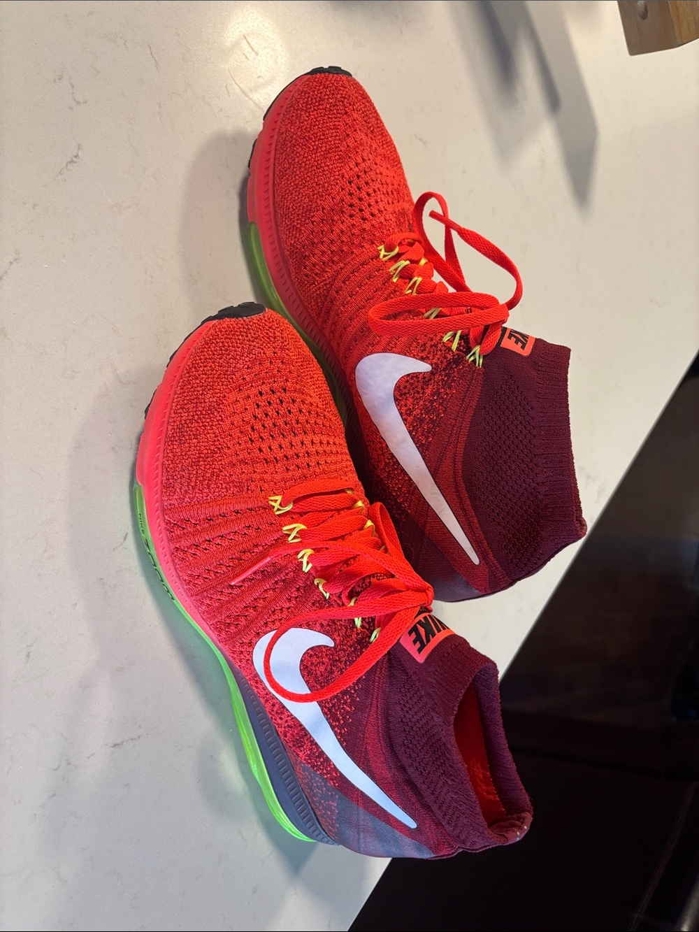 Nike Red Flyknit Racing Shoes with White Swoosh and Neon Green Accents